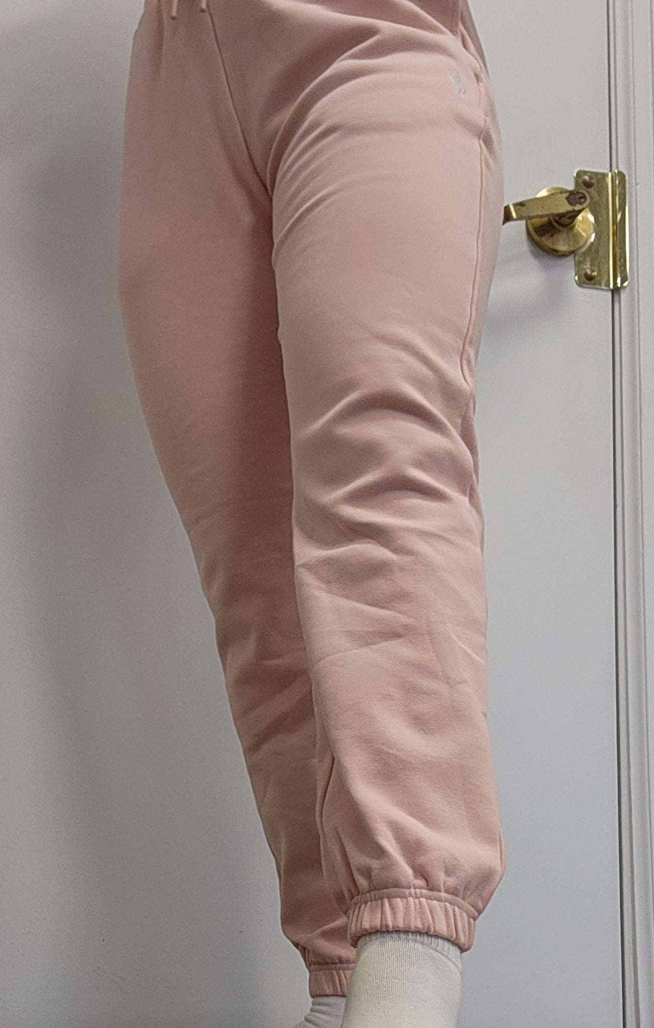 Woman modeling active-wear brand Sweat or Sparkle Athletics Millennial Pink Sweatpants.