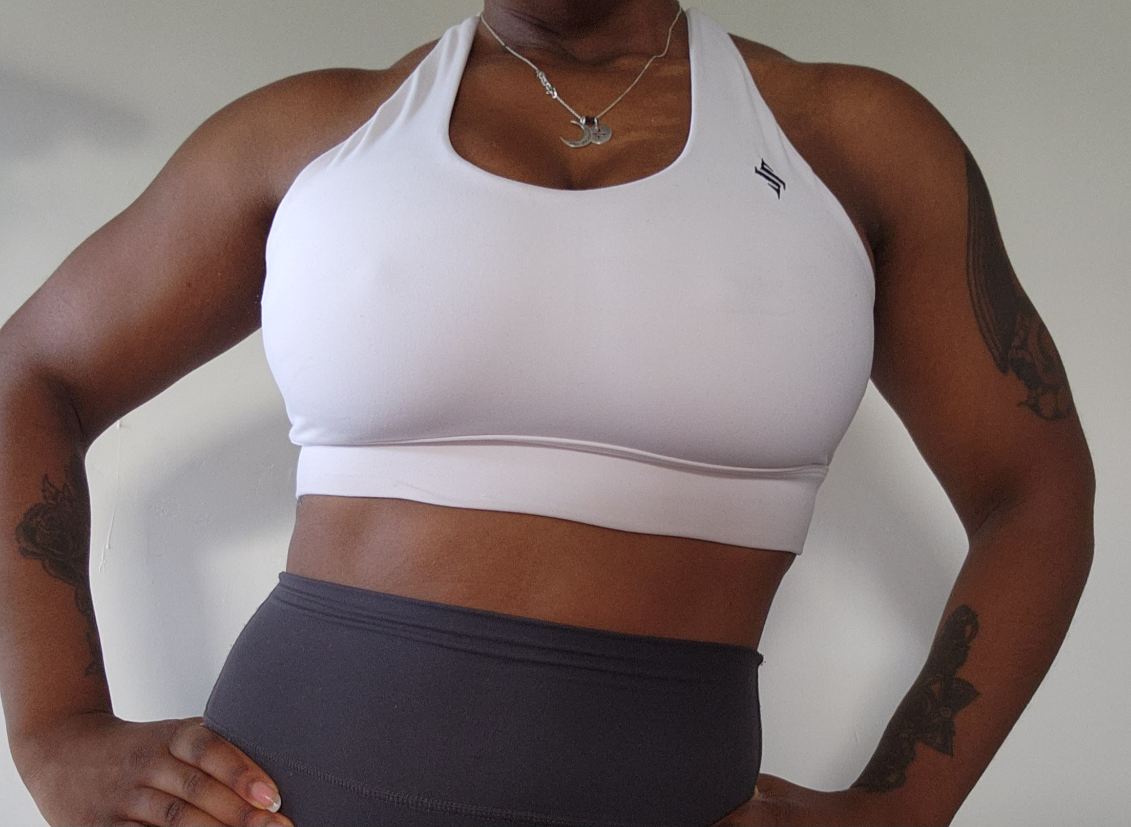 Woman modeling active-wear brand Sweat or Sparkle Athletics White Cross-Back Sports Bra.