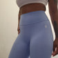 Woman modeling active-wear brand Sweat or Sparkle Athletics Carolina Blue Scrunch Leggings.