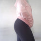 Woman modeling active-wear Sweat or Sparkle Athletics Millennial Pink Hooded Sweatshirt.