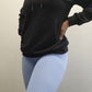 Woman modeling active-wear brand Sweat or Sparkle Athletics Black Hoodie.